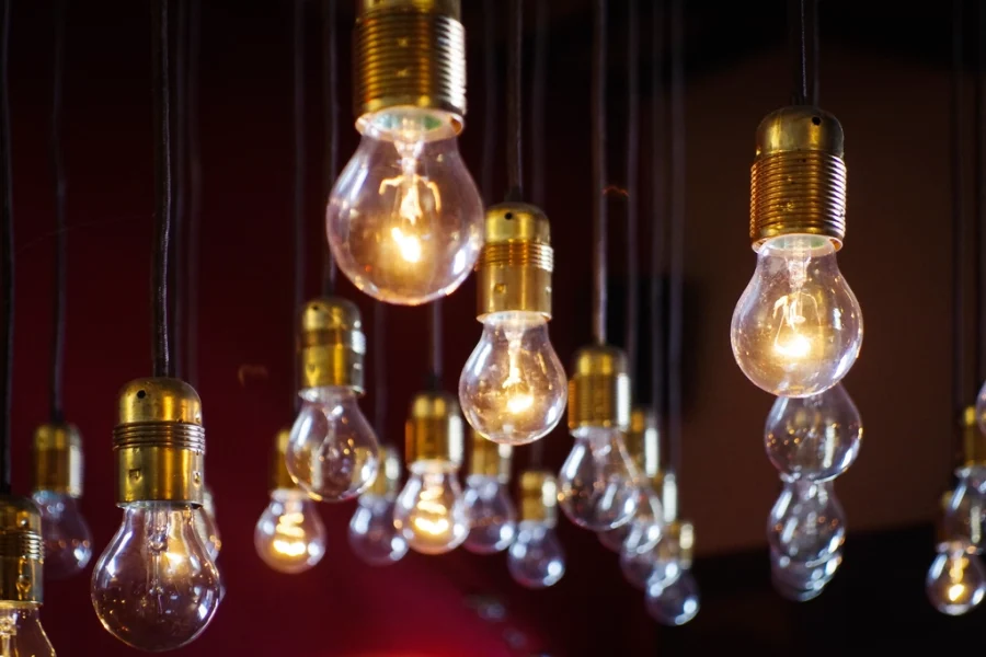 Glowing light bulbs hanging in front of a dark red wall